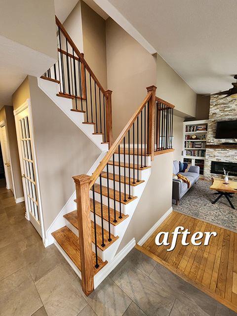 After image of a staircase renovation - wooden railing system replaced with metal.