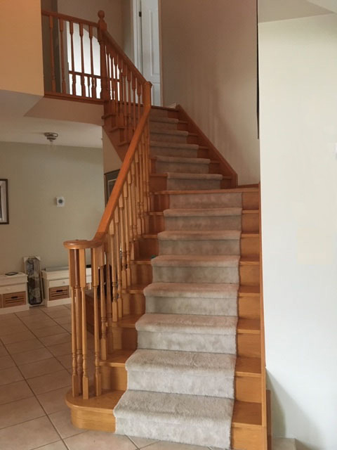 The before image of a staircase that was renovated.