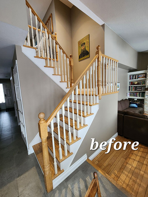 The before image of a staircase with a wooden rail system that was renovated with metal balusters.